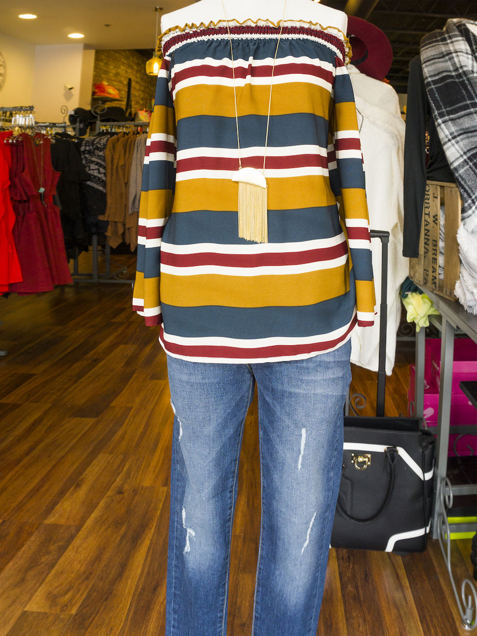Off-the-shoulder striped top, $39; Jeans, $75; Necklace, $25 Off-the-shoulder striped top, $39; Jeans, $75; Necklace, $25