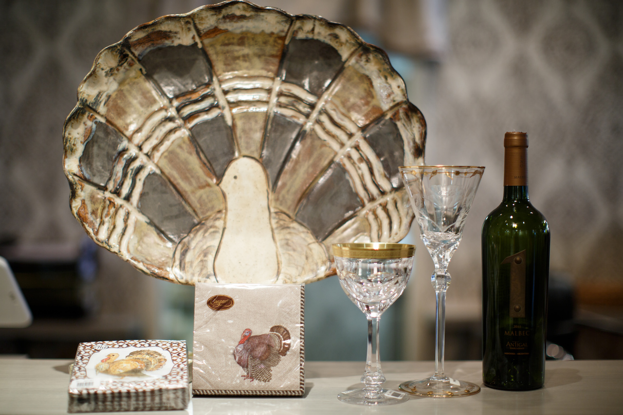 Gobble on with these awesome table necessities! From Babcock Gifts: Etta B Pottery turkey, $128; Roseanne Beck Collection cocktail napkins and Caspari cocktail napkins, $5.25 pack and gold-edged stemware, $275 and $640 each.