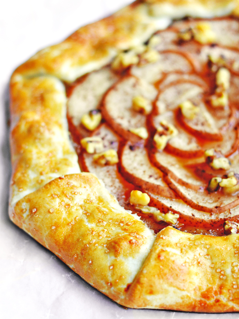 This golden crust topped with roasted pear slices and walnuts is the very picture of an ideal fall treat. This golden crust topped with roasted pear slices and walnuts is the very picture of an ideal fall treat.