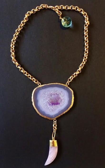 Talk about a statement! We adore this fierce agate slice necklace with an agate tusk drop. Talk about a statement! We adore this fierce agate slice necklace with an agate tusk drop.