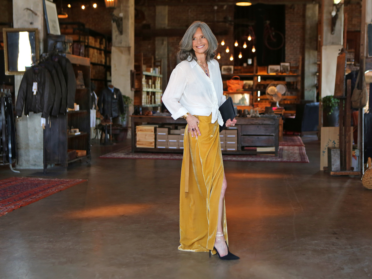 That velvet mustard skirt comes alive with the slit that lets gorgeous pumps peek out. We love everything about this Cavanagh Baker look, but especially the skirt!