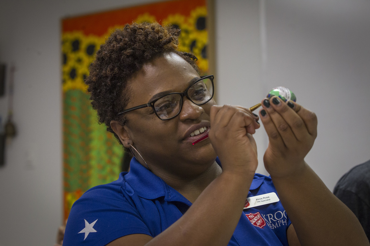 Alicia Rose, a PR specialist with the Salvation Army Kroc Center, paints a rock for the Kroc. Alicia Rose, a PR specialist with the Salvation Army Kroc Center, paints a rock for the Kroc.