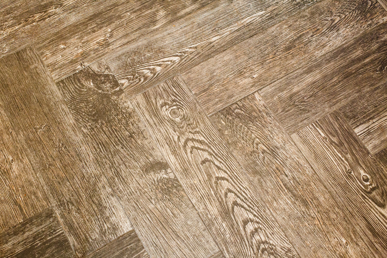 The wood floor's chevron pattern adds another dash of interest to the kitchen and dining area. The wood floor's chevron pattern adds another dash of interest to the kitchen and dining area.