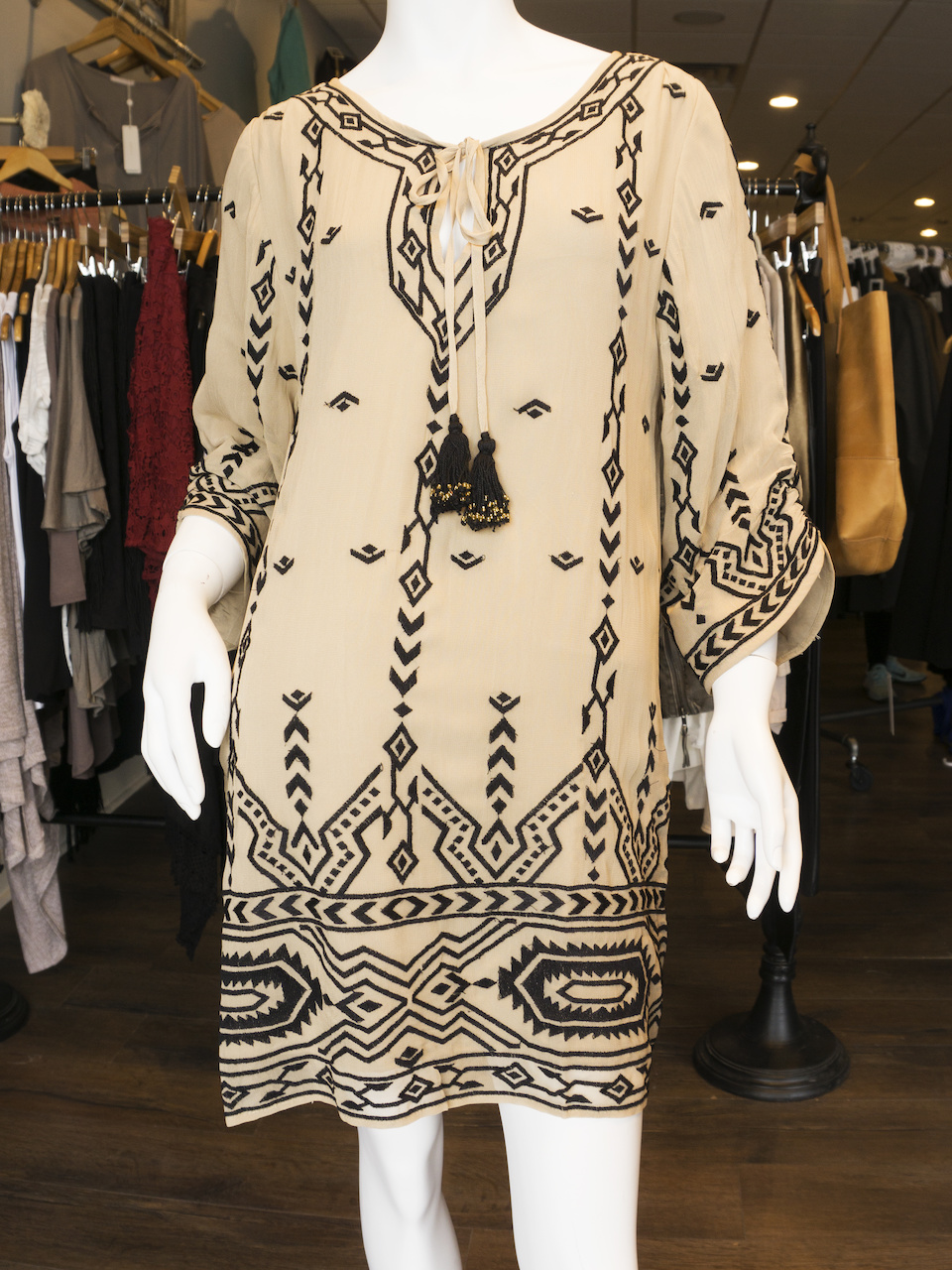 Tolani printed shift dress with tassle, $179; Black lace-up clogs, $89 Tolani printed shift dress with tassle, $179; Black lace-up clogs, $89