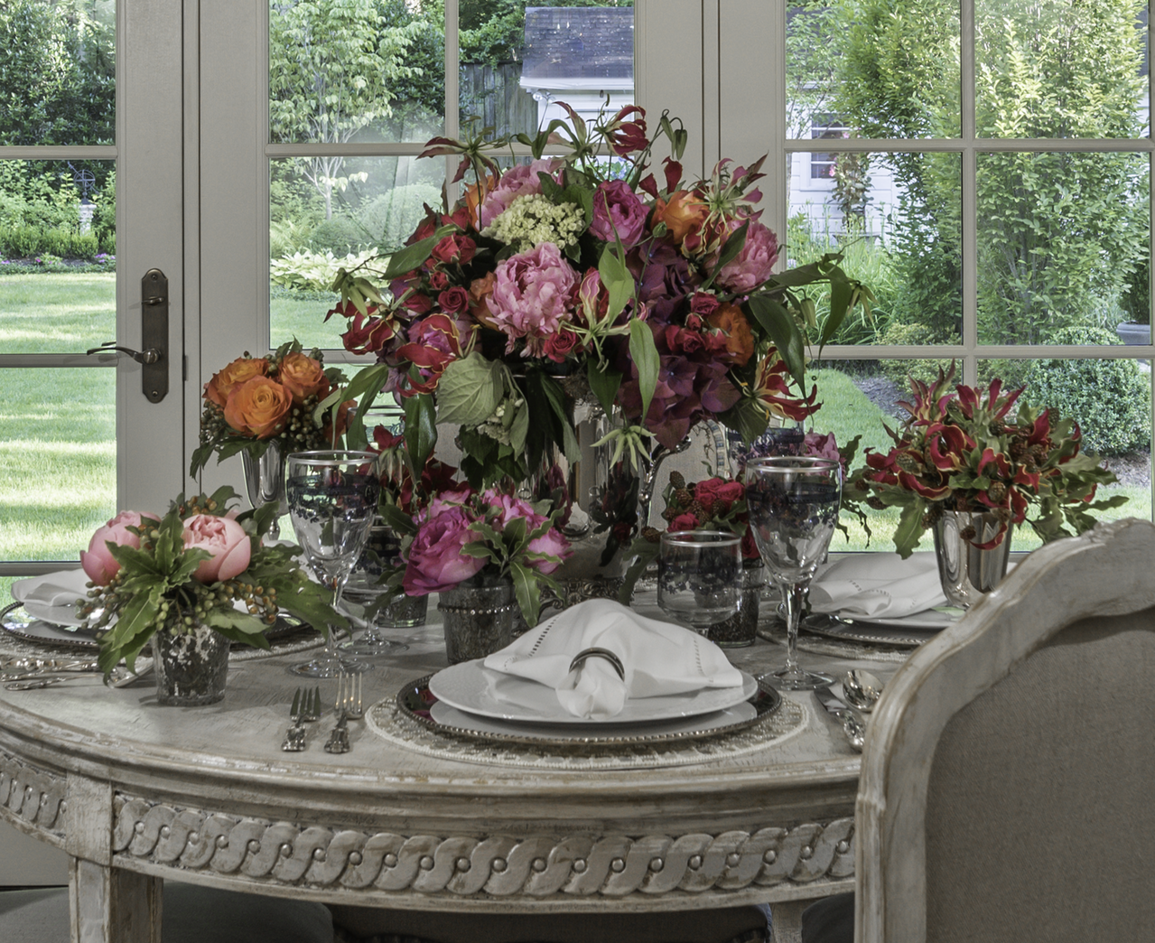 A cherished set of crystal stemware was selected for the table, because its purple-blue etched floral design effortlessly unites the flowers with the tableware in a delicate and chic style. A cherished set of crystal stemware was selected for the table, because its purple-blue etched floral design effortlessly unites the flowers with the tableware in a delicate and chic style.