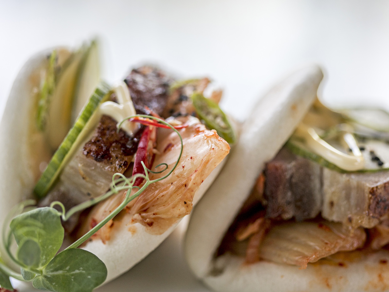 Pork belly buns feature house kimchi, spicy mayo and serrano pepper for $10. Pork belly buns feature house kimchi, spicy mayo and serrano peppers for $10.