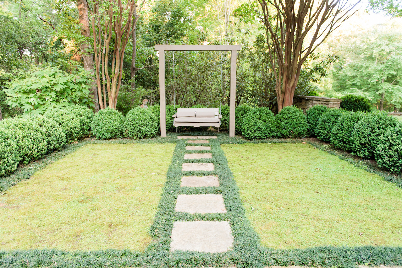 "The homeowners wanted a swing, so beside the family's 'pet cemetary,' we created a contemplative space surrounded with a boxwood hedge and mondo used to frame two rectangular moss rugs," says John. "The homeowners wanted a swing, so beside the family's 'pet cemetary,' we created a contemplative space surrounded with a boxwood hedge and mondo used to frame two rectangular moss rugs," says John.