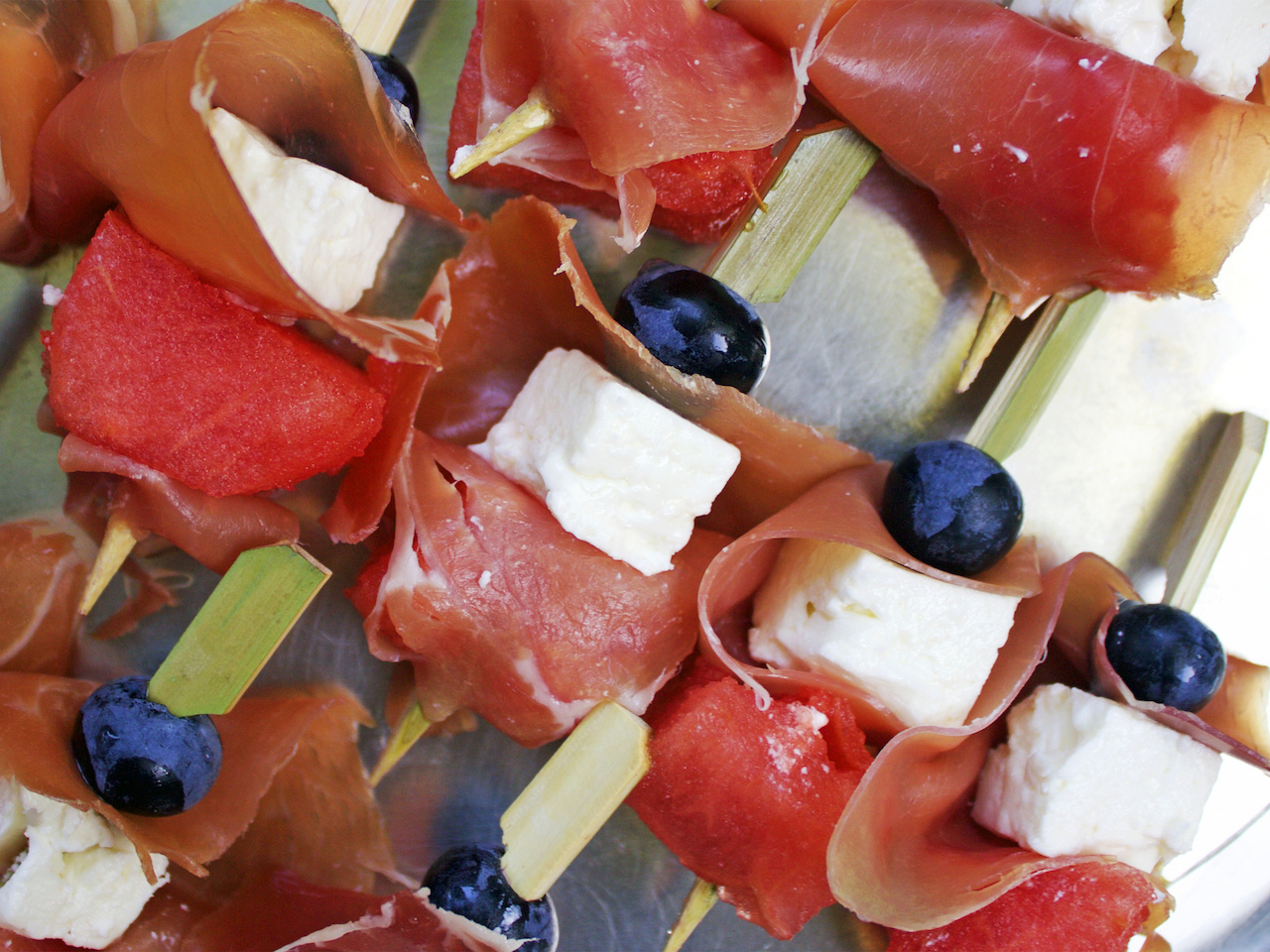 Salty and sweet adorn this skewer. Proscuitto, feta, watermelon and blueberry on this festive skewer.