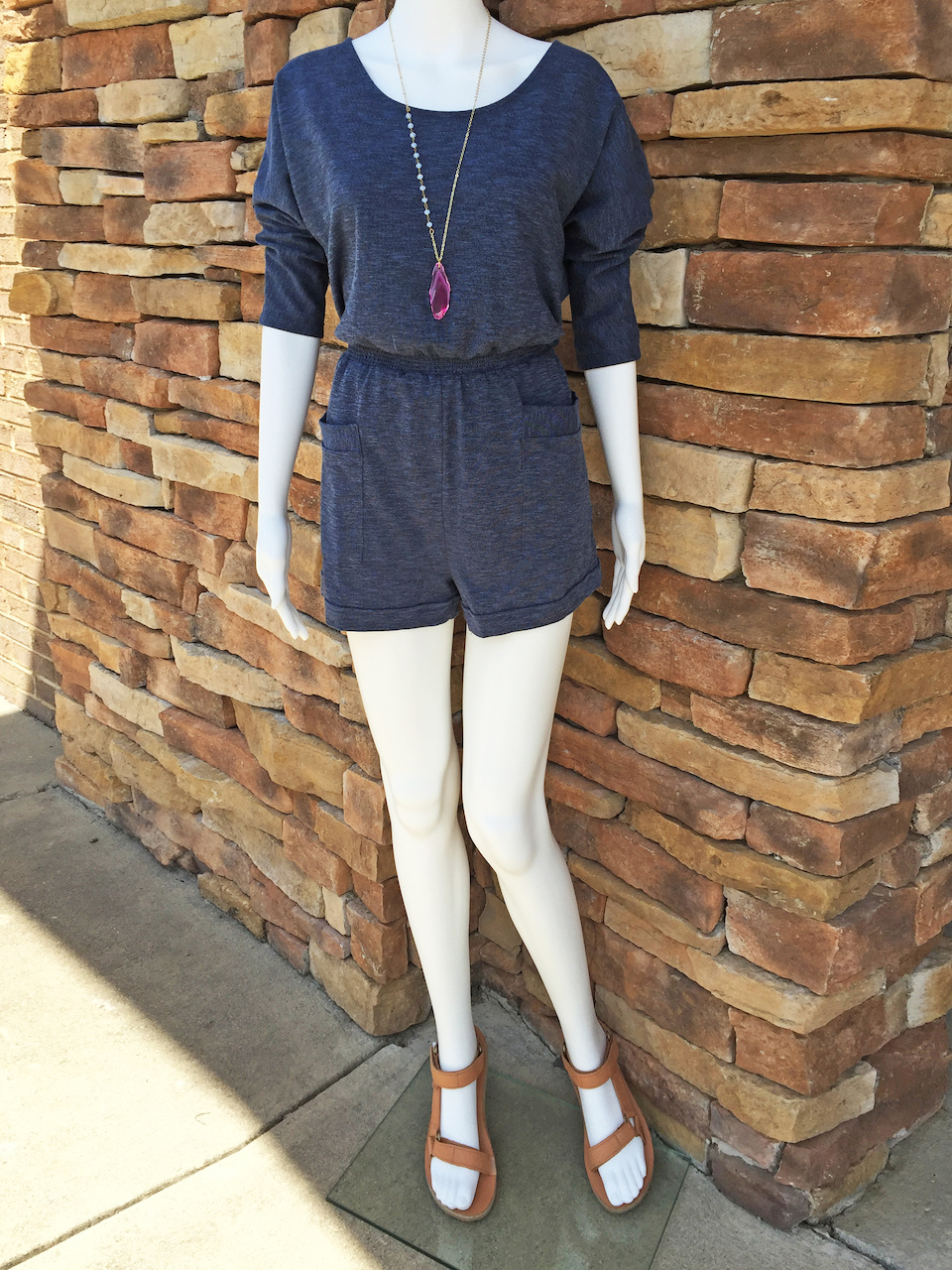 From Rogers Trading Company: denim knit romper, $49.99; Teva tan leather sandal, $89.95 From Rogers Trading Company: denim knit romper, $49.99; Teva tan leather sandal, $89.95