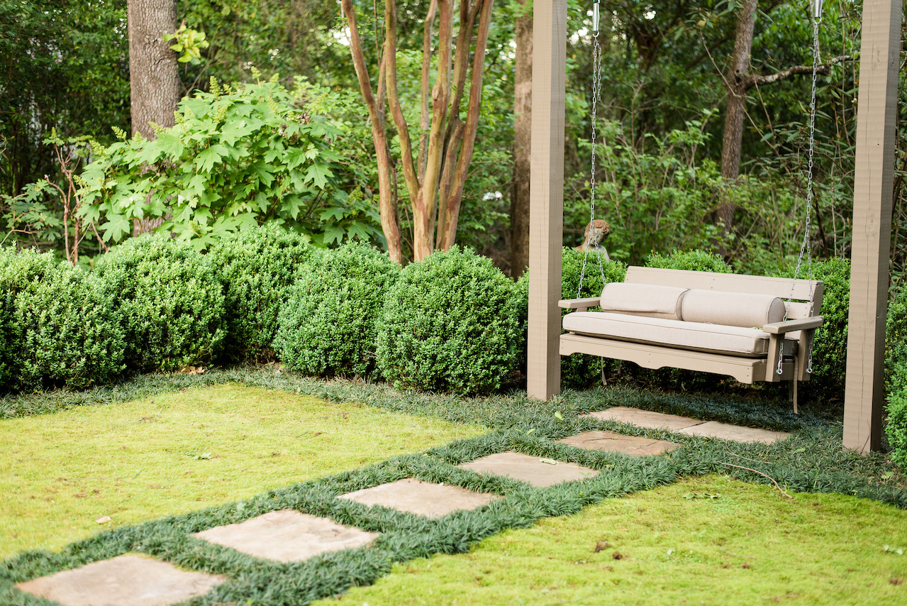 "A central stone paver walk divides the moss rugs leading to a swing looking back at the house," says John. "The moss was harvested from another area of the property and has thrived in its new setting." "A central stone paver walk divides the moss rugs leading to a swing looking back at the house," says John. "The moss was harvested from another area of the property and has thrived in its new setting."