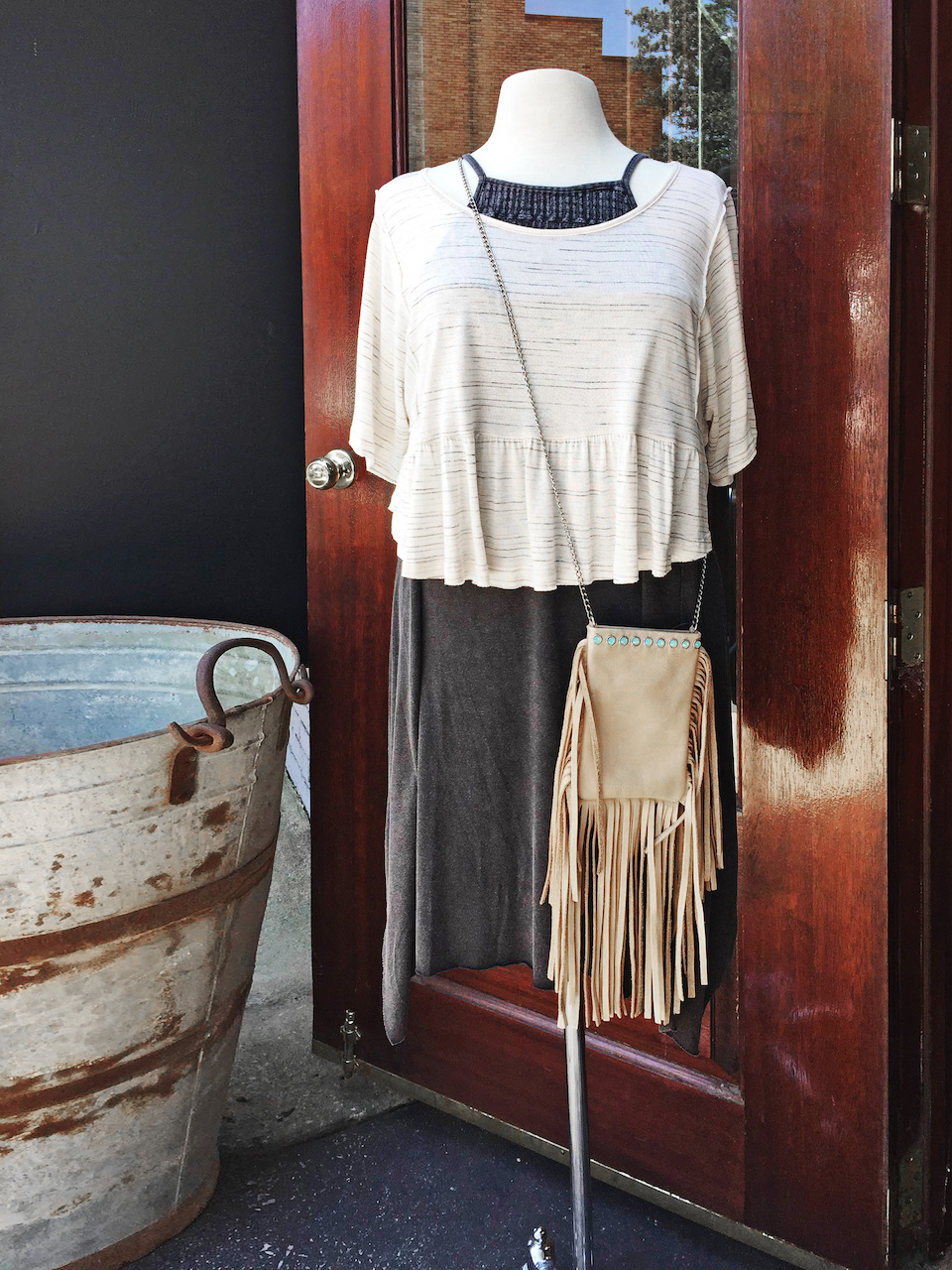 From Ambiance: black tank dress, $59; striped ruffle crop top, $39.99; leather fringe cross body, $139 From Ambiance: black tank dress, $59; striped ruffle crop top, $39.99; leather fringe cross body, $139