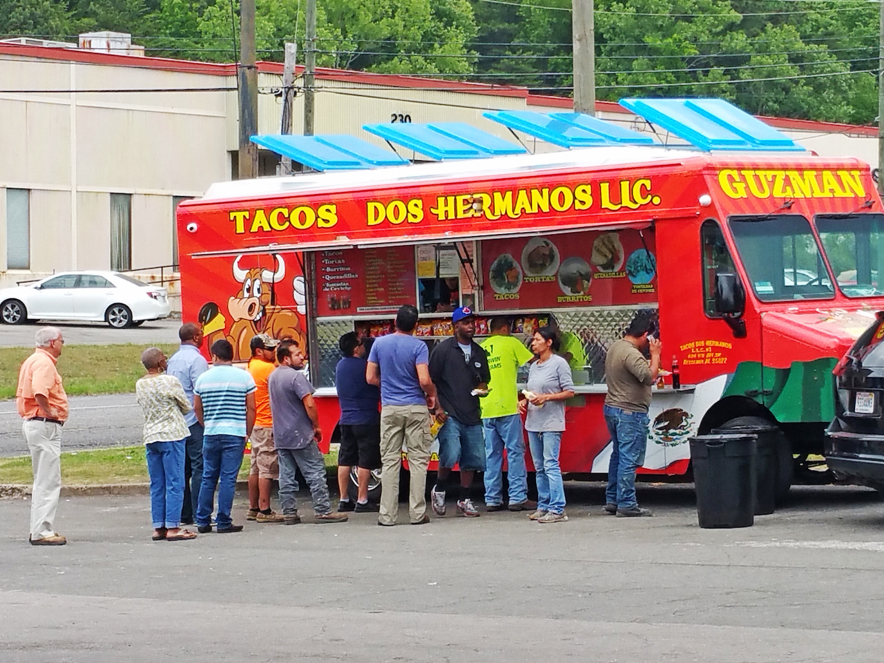 All walks of life can be found in line at the Dos Hermanos taco truck. All walks of life can be found in line at the Dos Hermanos taco truck.