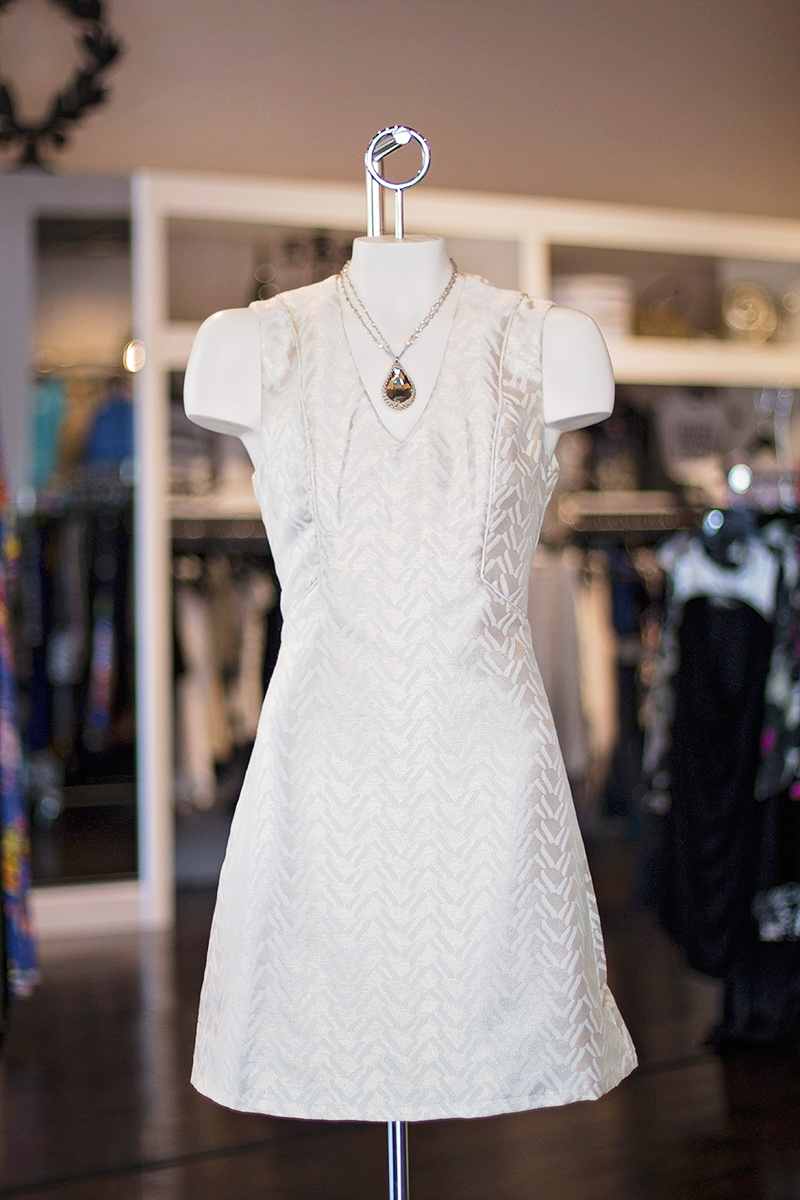 From Lori James: Shimmery gold patterned A-line dress, $245; Amber teardrop necklace, $75; Black strappy heels, $199; Metallic suede clutch, $215 From Lori James: Shimmery gold patterned A-line dress, $245; Amber teardrop necklace, $75; Black strappy heels, $199; Metallic suede clutch, $215