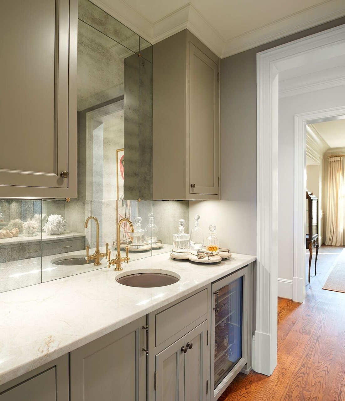 Antiqued-mirror walls line the butlers pantry, which has the convenience of a small sink for bar use. Antiqued-mirror walls line the butlers pantry, which has the convenience of a small sink for bar use.