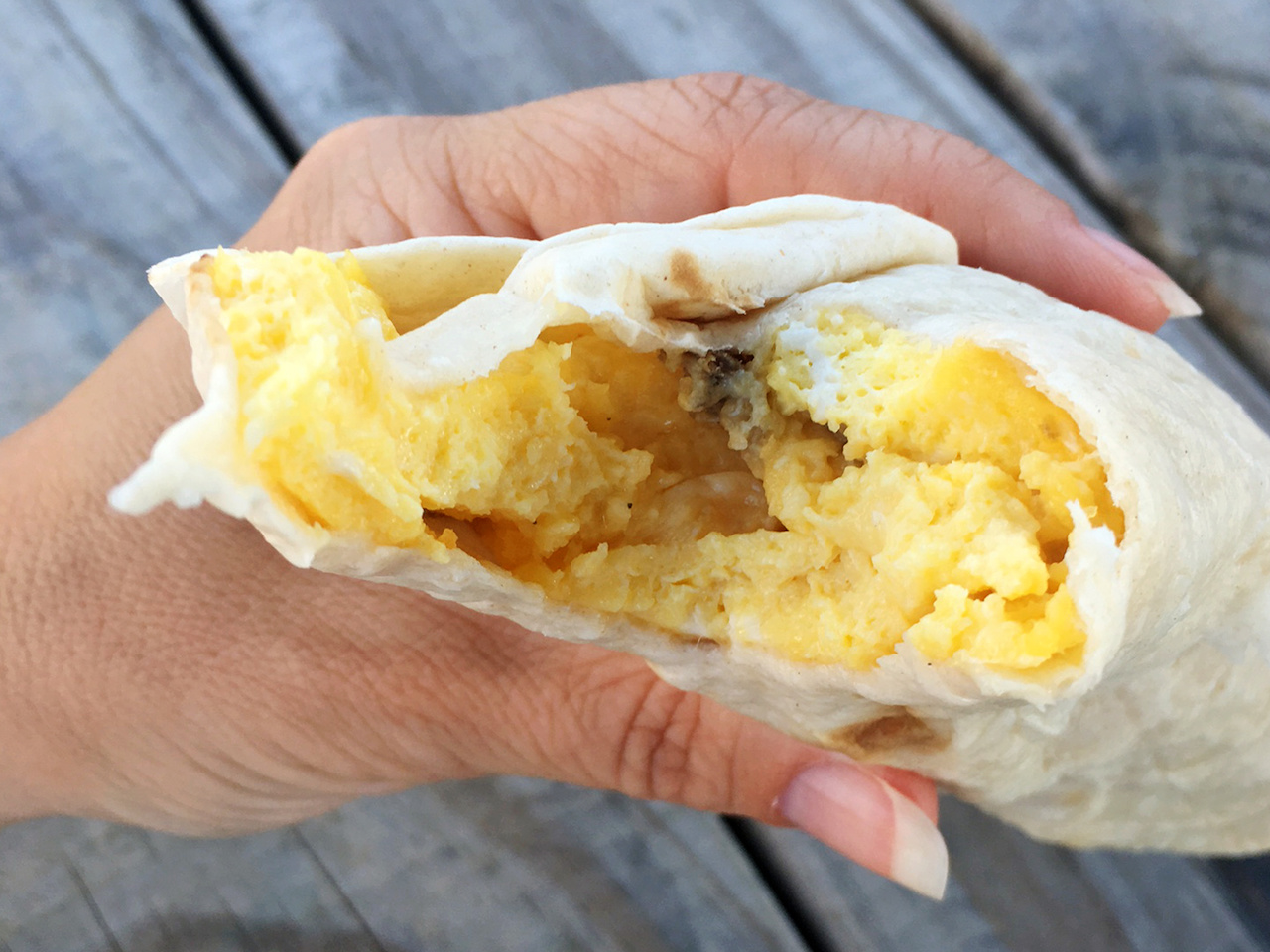 Breakfast burrito loaded with eggs and spicy sausage. Good eats at the Louisville Farmers Markets