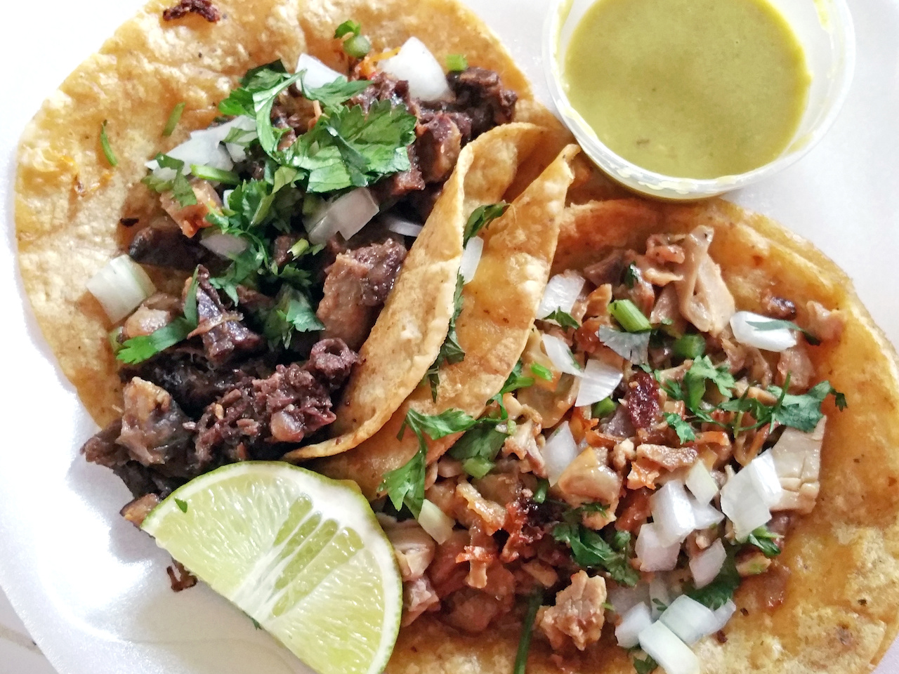 Dos Hermanos' pork belly and beef cheek tacos served with lime and a tantalizingly addictive green sauce keeps you coming back for more. Dos Hermanos' pork belly and beef cheek tacos served with lime and a tantalizingly addictive green sauce keeps you coming back for more.