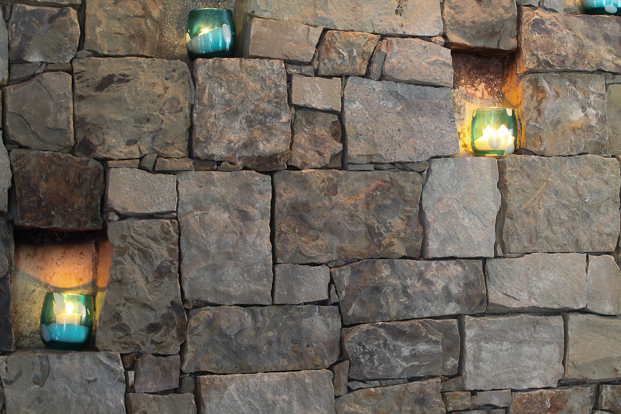 The fireplace was built intentionally to have places to hold candles.
