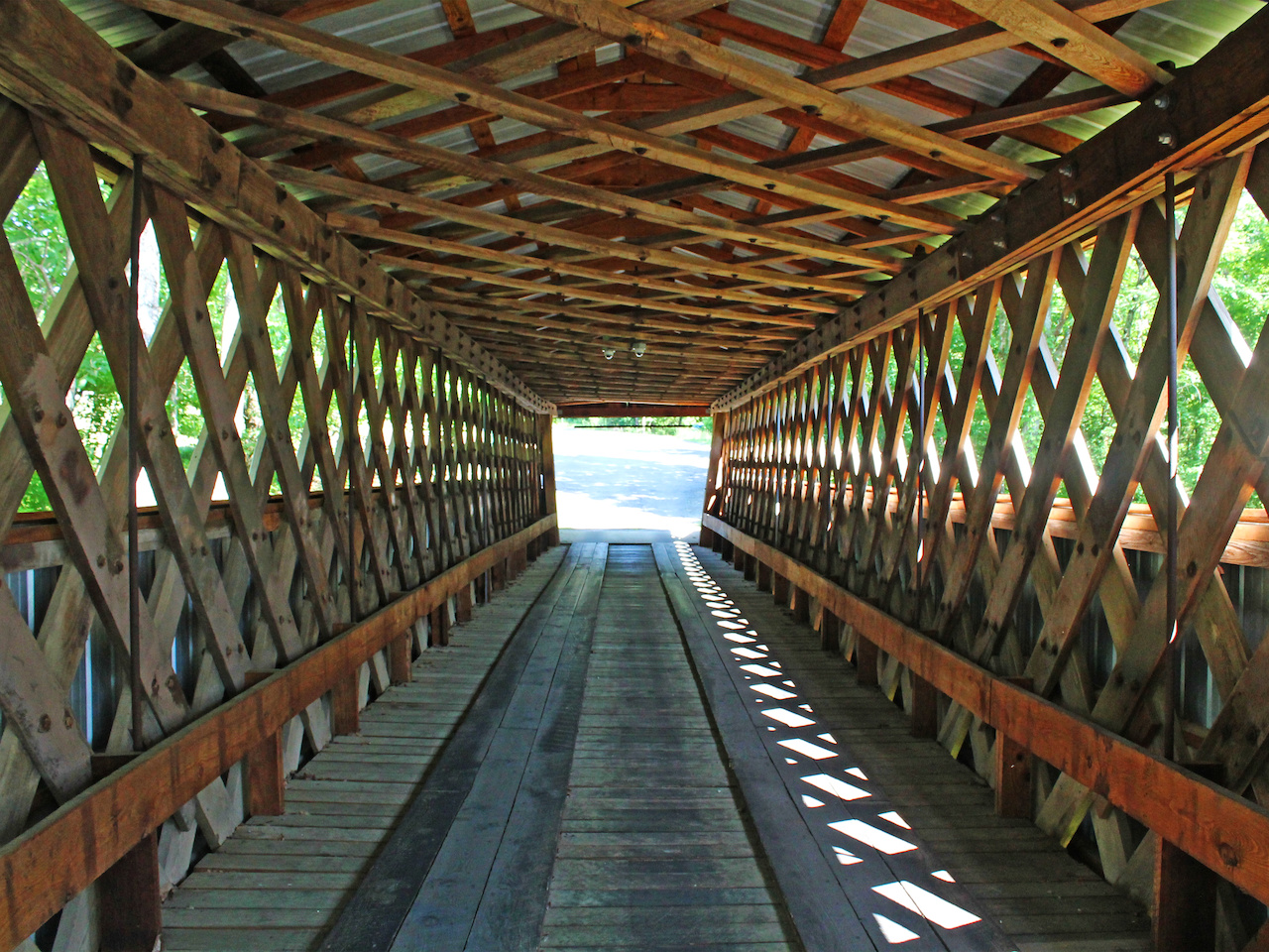 The interior of a covered bridge offers respite from the summer sun! The interior of a covered bridge offers respite from the summer sun!