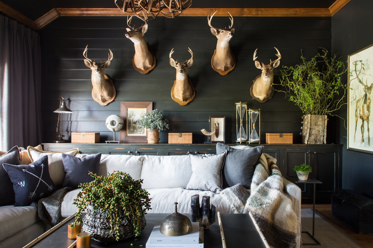An impressive collection of deer is showcased on the dark walls of this masculine space. An impressive collection of deer is showcased on the dark walls of this masculine space.