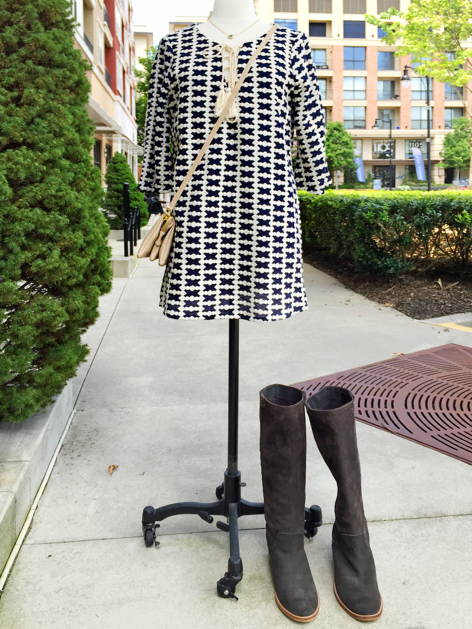 Boots look great with a short dress or long tunic shirt. Collage Boutique tassel dress StyleBlueprint Atlanta