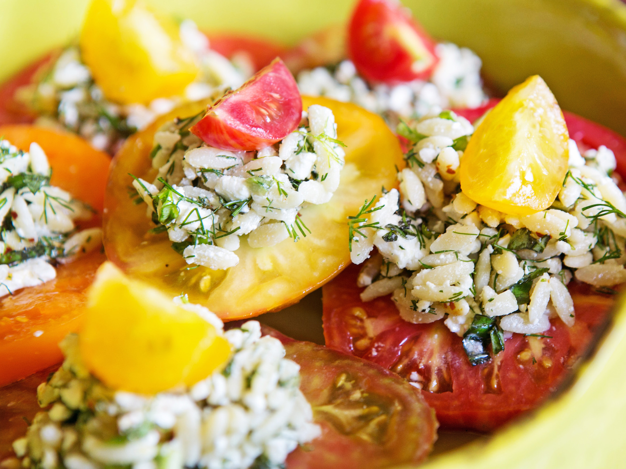 Finish each orzo salad-topped tomato with an alternating colored cherry tomato for a truly eye-catching dish! Finish each orzo salad-topped tomato with an alternating colored cherry tomato for a truly eye-catching dish!
