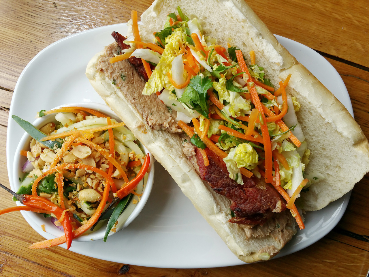 Pork belly bahn mi on crispy bread with bright crunchy veggies Pork belly bahn mi on crispy bread with bright crunchy veggies