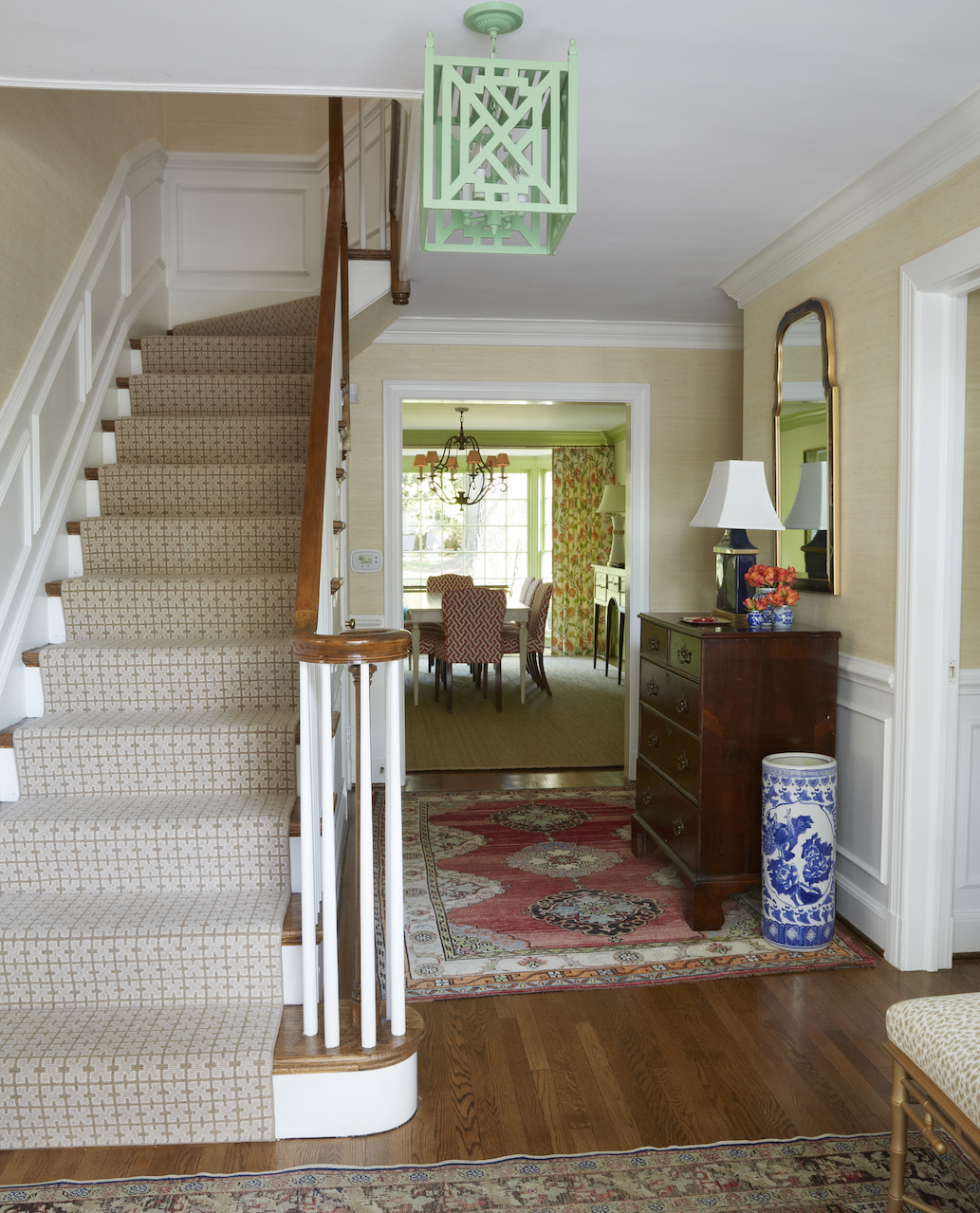 A striking light fixture from John Roselli Antiques in New York adds just the right amount of unexpected alongside classic foyer furnishings. A striking light fixture from John Roselli Antiques in New York adds just the right amount of unexpected alongside classic foyer furnishings.