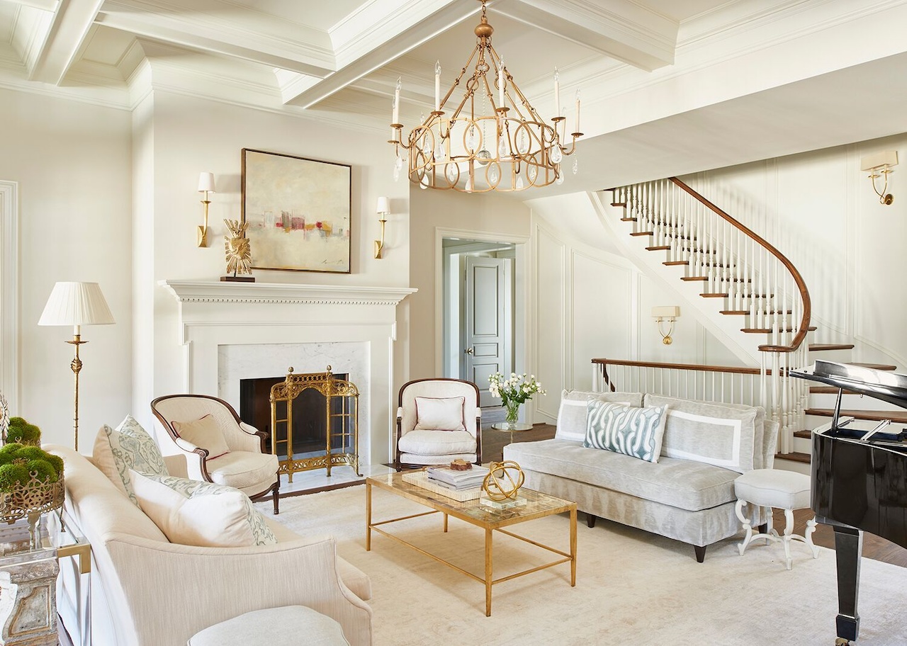 Designer Lyndsy Woods painted the living room walls Benjamin Moore York Gray (tinted at 50% strength) and the trim Benjamin Moore White Dove as a crisp backdrop for traditional furnishings. A custom light fixture from Solaria Lighting picks up curvilinear shapes elsewhere in the house. Designer Lyndsy Woods painted the living room walls Benjamin Moore York Gray (tinted at 50% strength) and the trim Benjamin Moore White Dove as a crisp backdrop for traditional furnishings. A custom light fixture from Solaria Lighting picks up curvilinear shapes elsewhere in the house.