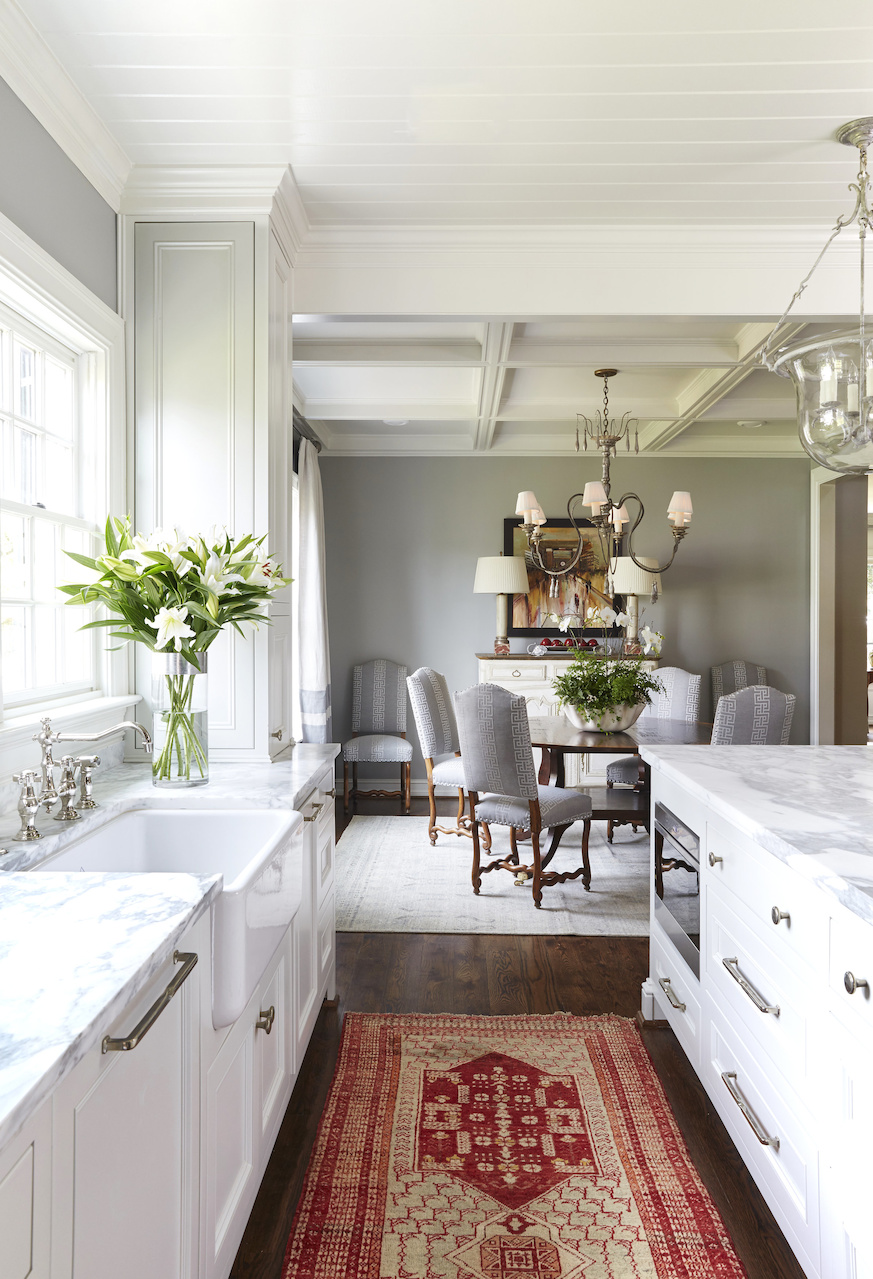 The Calcutta silver marble gleams in the natural light. One of the Paige Albright Orientals' rugs offers the requisite pop of crimson in this Roll Tide refuge. Local artist Dirk Walker did the Bryant-Denny Stadium painting in the dining room.