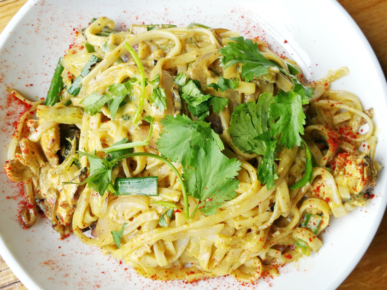 Yellow curry noodles with with chicken, scallion and cilantro Yellow curry noodles with with chicken, scallion and cilantro