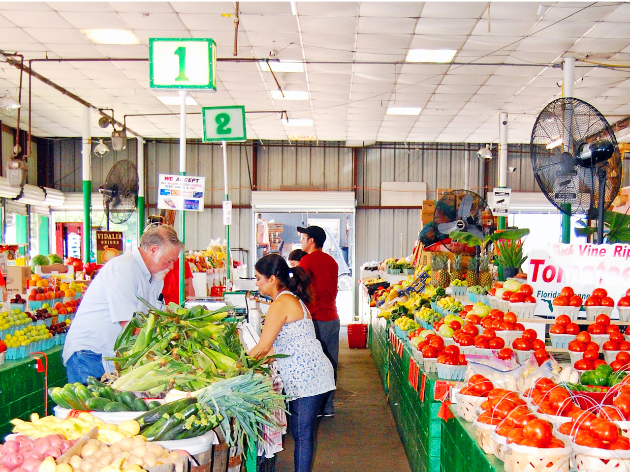 Large fans keep customers cool as they peruse the colorful rows of fresh veggies. Large fans keep customers cool as they peruse the colorful rows of fresh veggies.