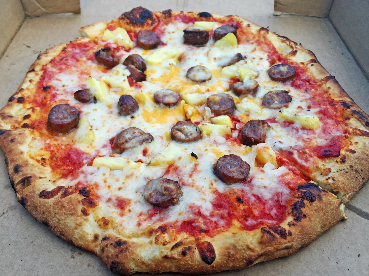 The Southern Hawaii is a perfect mix of Conecuh sausage, fresh cut pineapple and a mix of provolone and mozzarella — Yum! The Southern Hawaii is a perfect mix of Conecuh sausage, fresh cut pineapple and a mix of provolone and mozzarella — Yum!