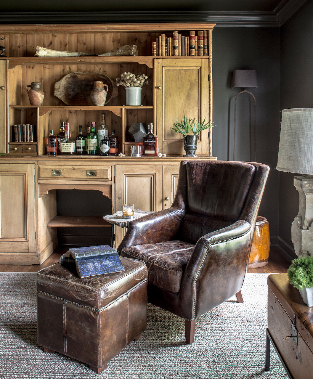 The dark walls and earthy hues enhance the timeless atmosphere of this library / sitting room. The dark walls and earthy hues enhance the timeless atmosphere of this library / sitting room.