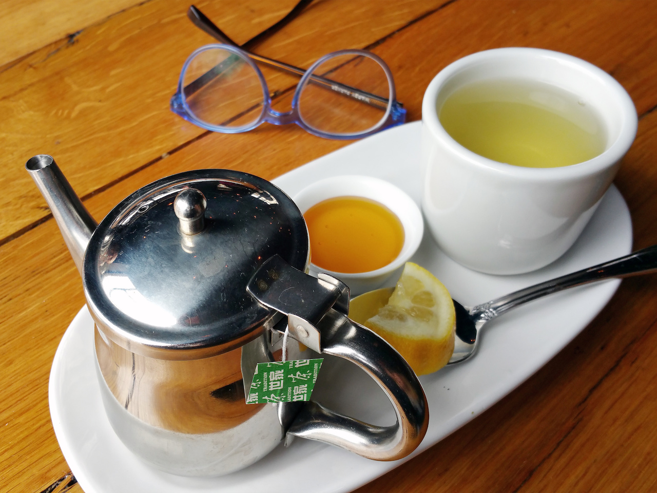 Green tea with honey and lemon at wooden goat Green tea with honey and lemon at wooden goat