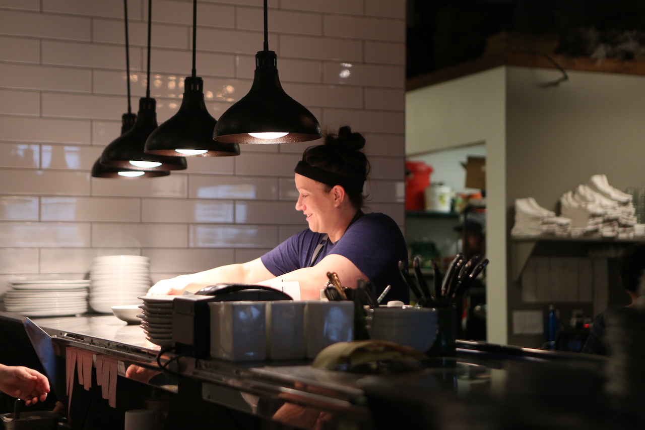 Chef Sarah Bradley, owner of Freight House, artfully directs her team through another busy Saturday night of creating beautiful, delicious dishes. Chef Sarah Bradley, owner of Freight House, artfully directs her team through another busy Saturday night of creating beautiful, delicious dishes.
