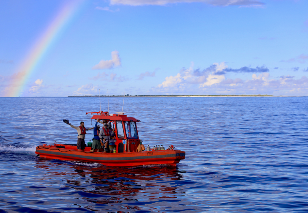 One of the small boats returns to the ship under a rainbow after collecting water samples and deploying instruments around Kure Atoll. <i>Photo: NOAA Fisheries/James Morioka. </i>