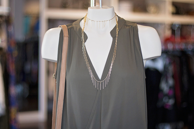 The long spike necklace adds a bit of shimmer and interest to the neutral olive top. The long spike necklace adds a bit of shimmer and interest to the neutral olive top.