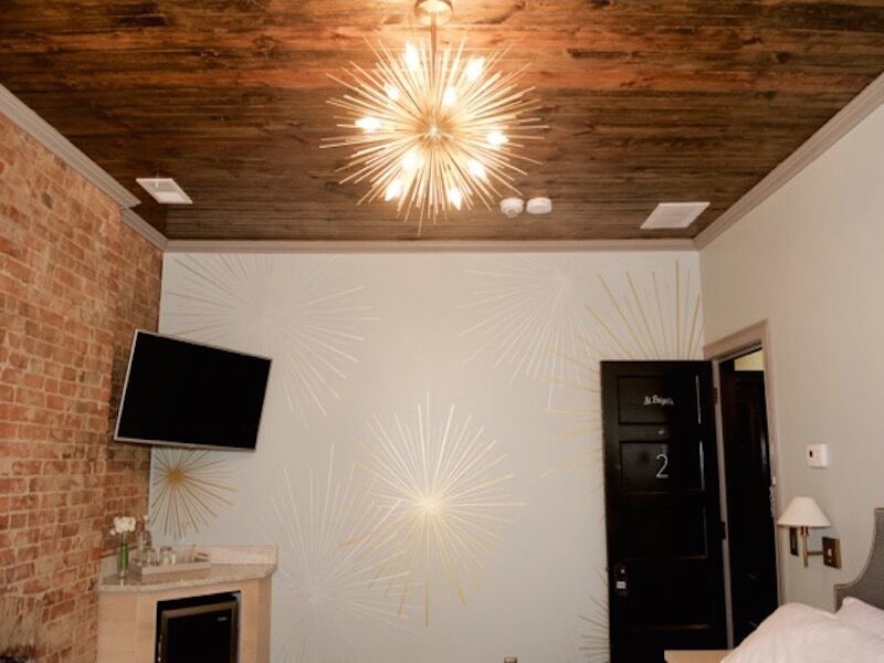 painted starbursts on the wall mimic the light fixture Gralehaus Bed and Beverage