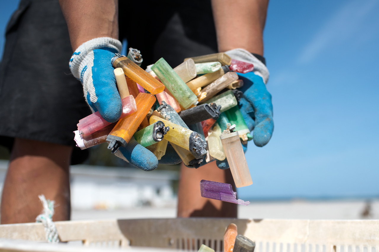 On April 23, 2016, the team sorted debris removed from the shorelines of Midway Atoll. Sixty percent of the 7077 kg (15602 lbs) debris collected has been sorted and tallied, and a total of 366 disposable cigarette lighters have been counted. Photo: NOAA Fisheries/David Slater