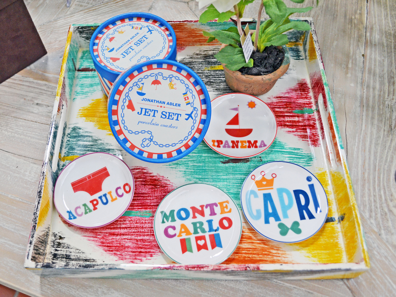 All your dream vacations wrapped up in a coaster set Multi-colored tray and Jonathan Adler "Jet Set" coasters at Lee W. Robinson