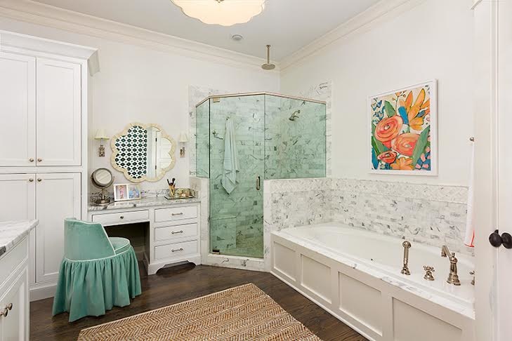 If intimidated to decorate with color, try adding colorful accessories, like the painting above the bath. master bath has effective lighting and color