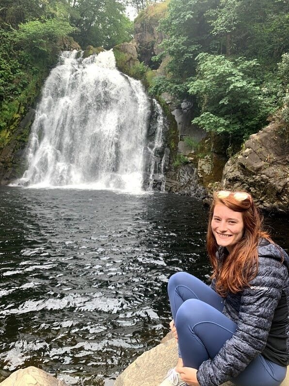 Rachel Sanchez seated near a waterfall