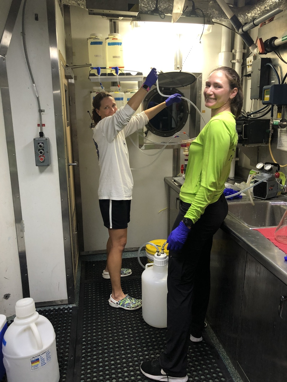 Marie Hill and Ann Allen filter water samples collected at various depths over Cross Seamount to collect environmental DNA samples. The acoustics team will listen to the recordings to determine if the "Cross Seamount beaked whale" was present in the area. If a Cross Seamount beaked whale vocalized during the CTD cast, then we will send our eDNA samples to Oregon State University's genetic lab for species identification. Photo: NOAA Fisheries/Jennifer McCullough.
