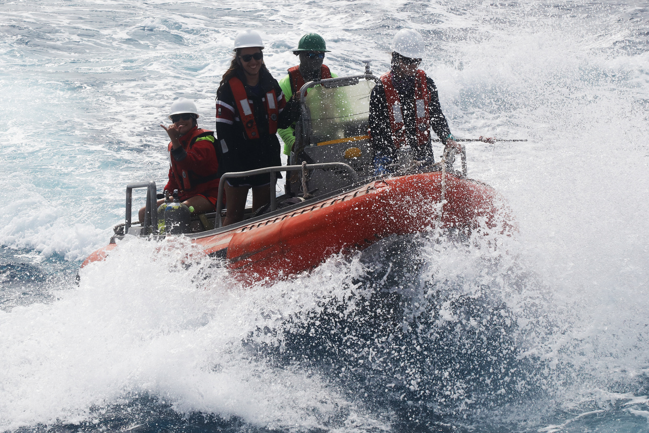 Sunday brought rough seas to the windward side of O'ahu, but our scientists carried on with diving surveys. They came to collect data on the nearshore reef fish community. Safety gear in place and smiles all around, this team of divers returns to the NOAA Ship <i>Sette</i> after a successful day of fighting swells and surge. <br><i>Photo: NOAA Fisheries/Raymond Boland.</i>