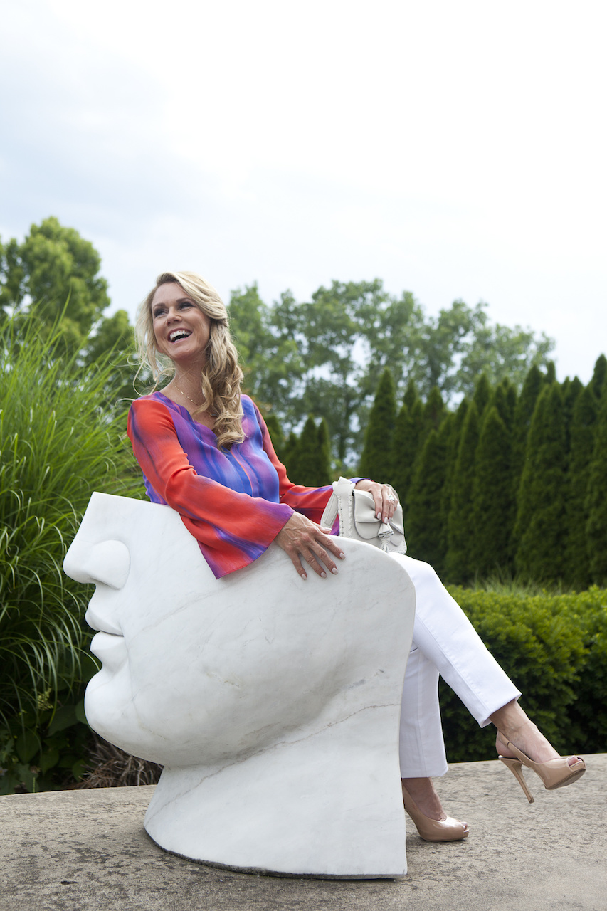 Arnita Ozgener for StyleBlueprint, wearing white jeans and a blouse found at Gus Mayer.