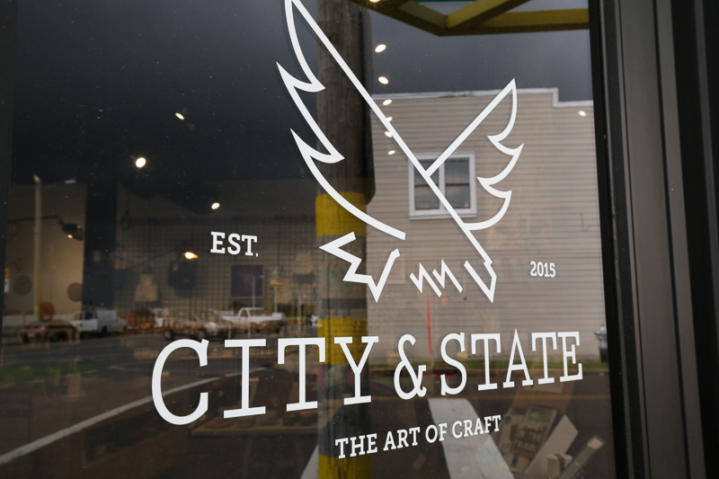 City & State occupies a great corner space on Broad Avenue, and features both the sleek coffee shop with food from Porcellino's, and a store dedicated to showcasing crafters and makers from across the country. City & State occupies a great corner space on Broad Avenue, and features both the sleek coffee shop with food from Porcellino's, and a store dedicated to showcasing crafters and makers from across the country.