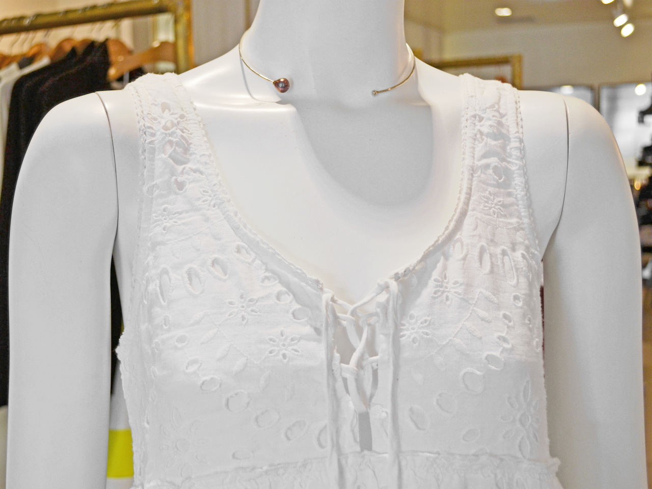 Closeup of modern pearl choker and lace-up detail on the dress june what to wear