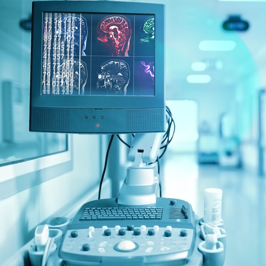 A grey portable monitor displays a grid of six diffferent views of a patient's brain scan A grey portable monitor displays a grid of six diffferent views of a patient's brain scan