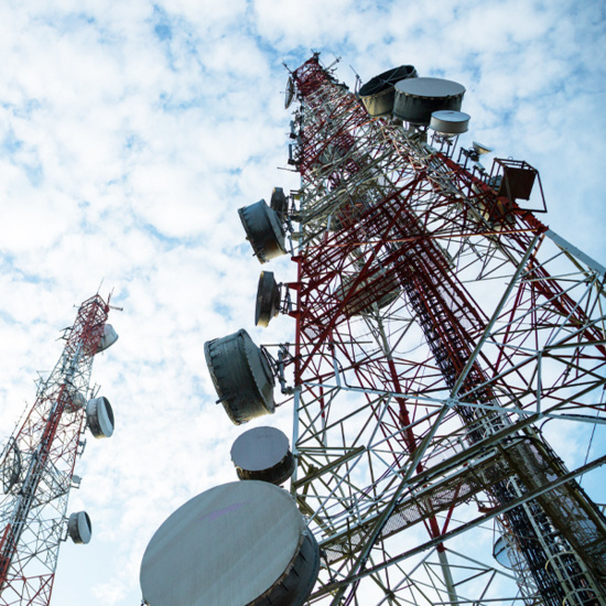 Two cell towers viewed up close and from the ground