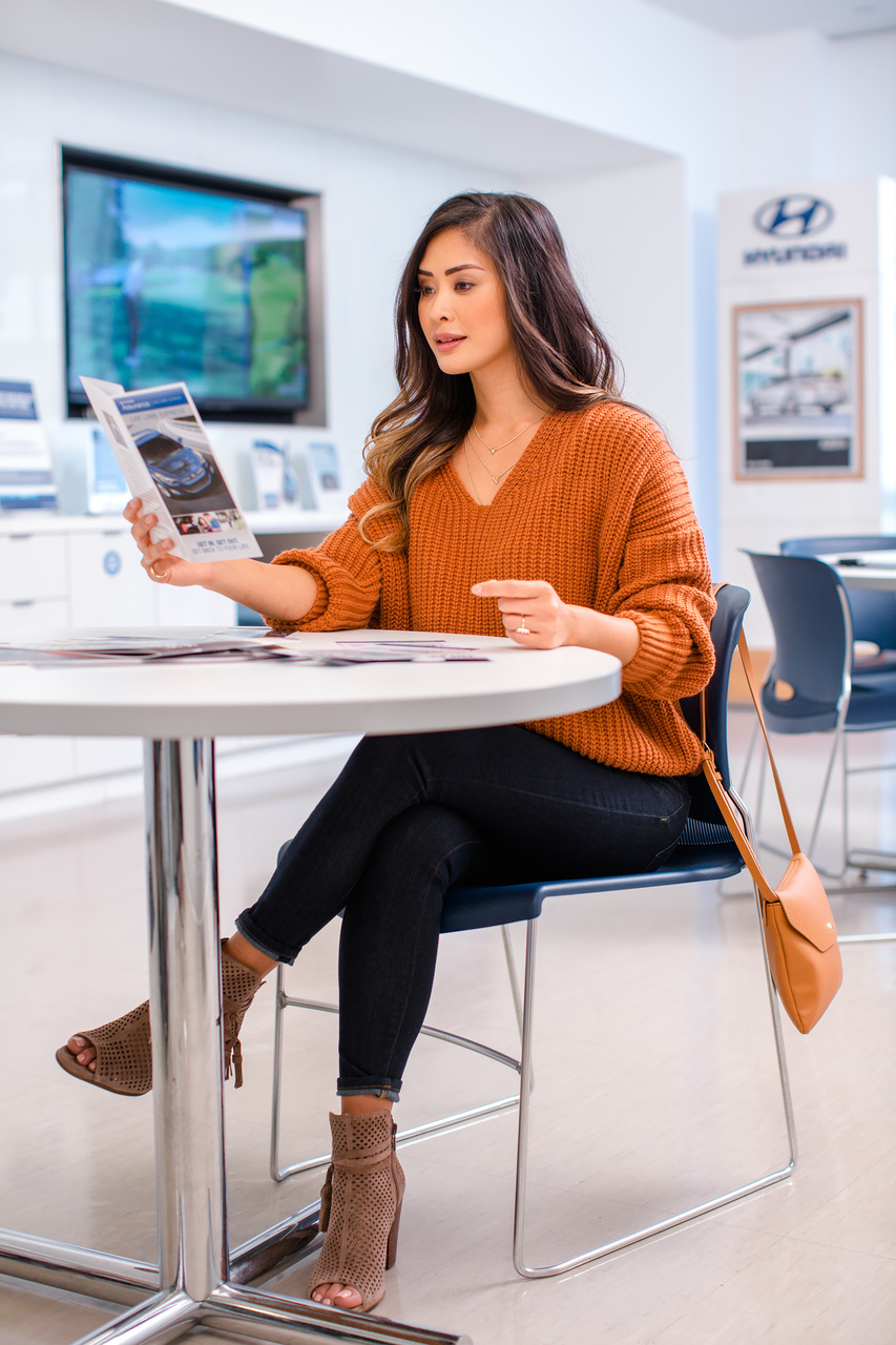  Person cheerfully signing documents.
